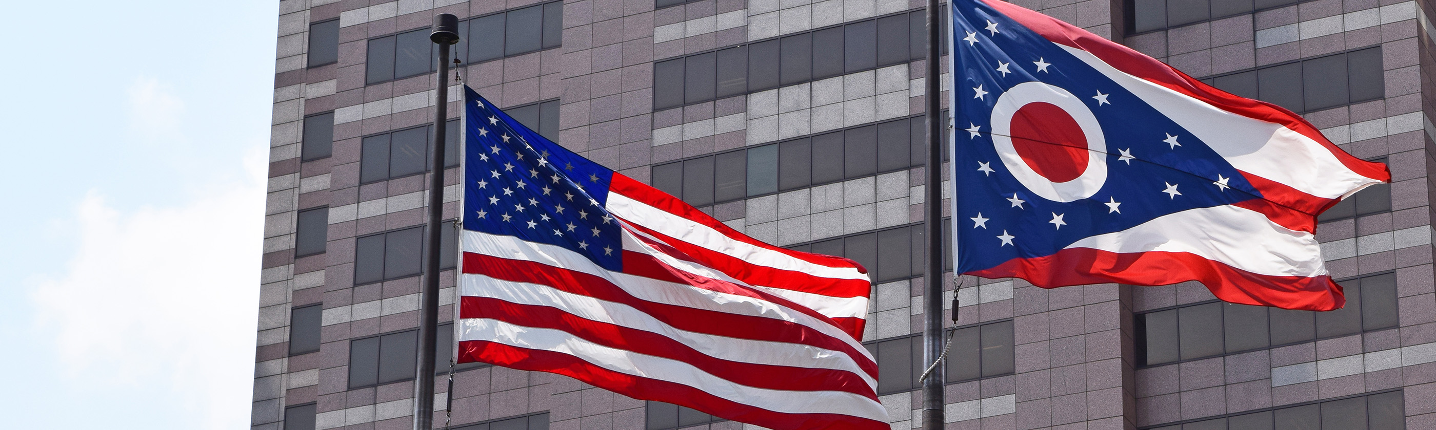 The American and Ohio Flags on display outside a state office building.