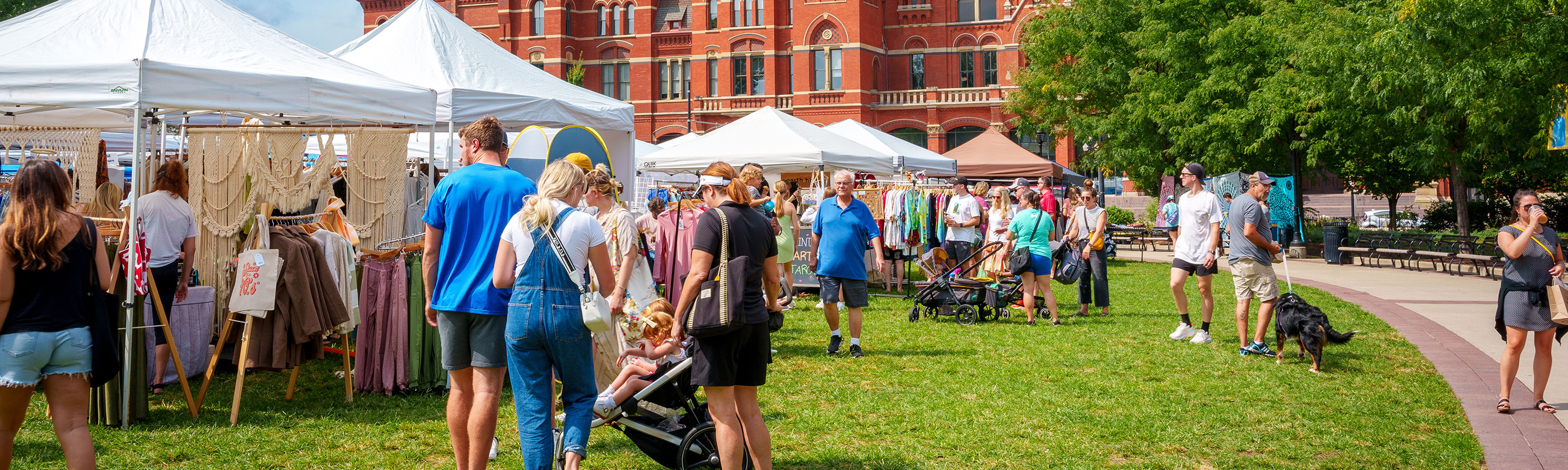 Community residents and visitors enjoy an outdoor fair.